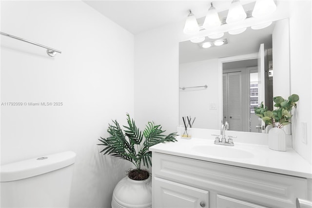 bathroom with toilet and vanity