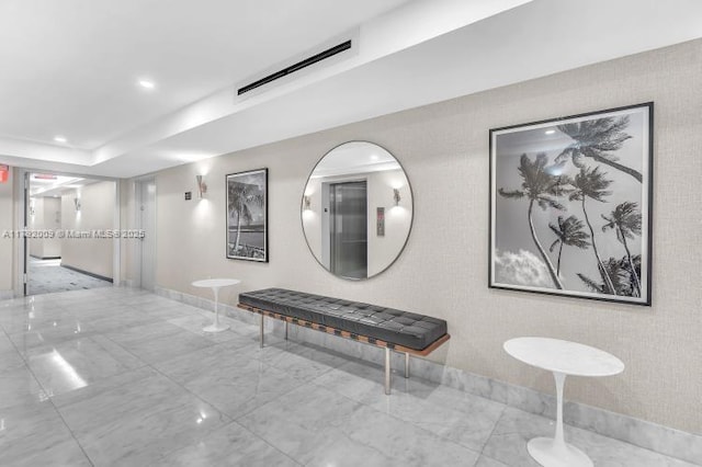 hallway with visible vents, marble finish floor, baseboards, and recessed lighting