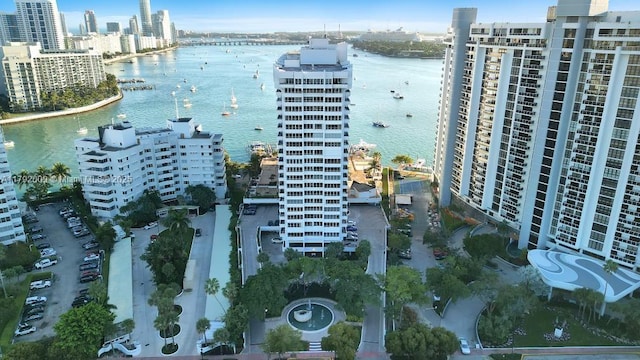 drone / aerial view featuring a city view and a water view