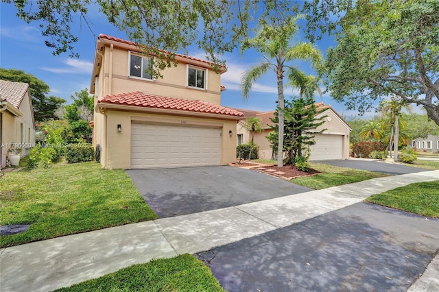 mediterranean / spanish home featuring an attached garage, stucco siding, a tile roof, a front lawn, and driveway
