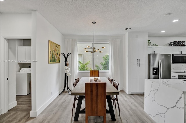 1381 Sago Ln, Weston, FL 33327 - dining room with light wood-style floors, washer / dryer, an inviting chandelier, and a textured ceiling