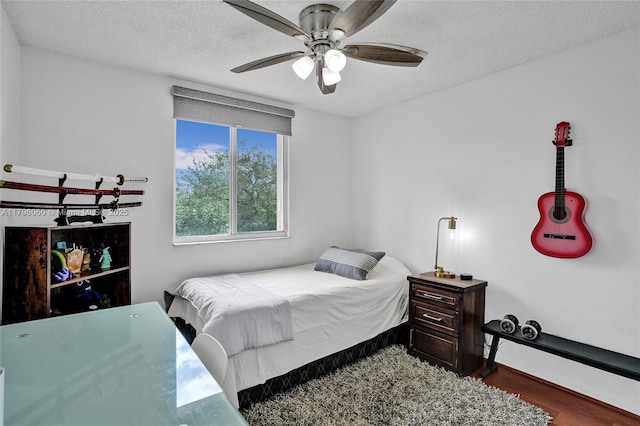 1381 Sago Ln, Weston, FL 33327 - bedroom featuring a textured ceiling, wood finished floors, baseboards, and ceiling fan
