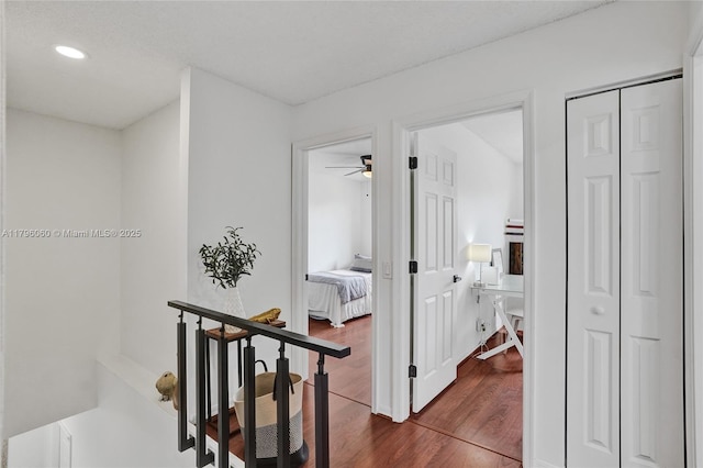 corridor with recessed lighting and dark wood-style floors