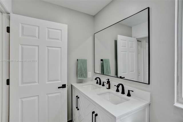 bathroom with double vanity and a sink