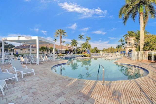 1381 Sago Ln, Weston, FL 33327 - community pool featuring a patio and fence
