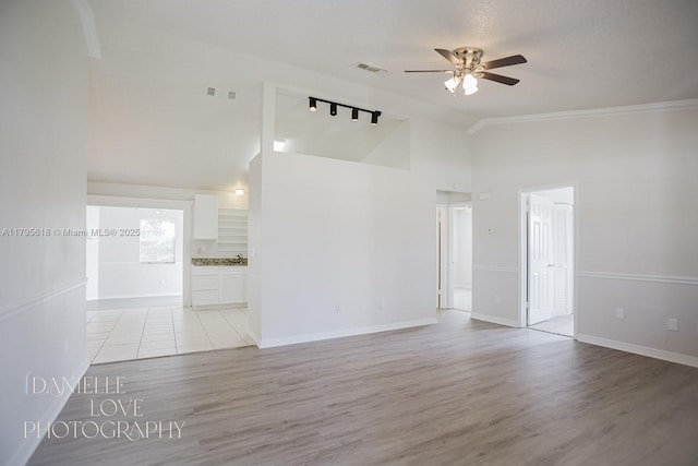 557 NW Fairfax Ave, Port St Lucie, FL 34983 - unfurnished living room featuring track lighting, visible vents, ceiling fan, and high vaulted ceiling