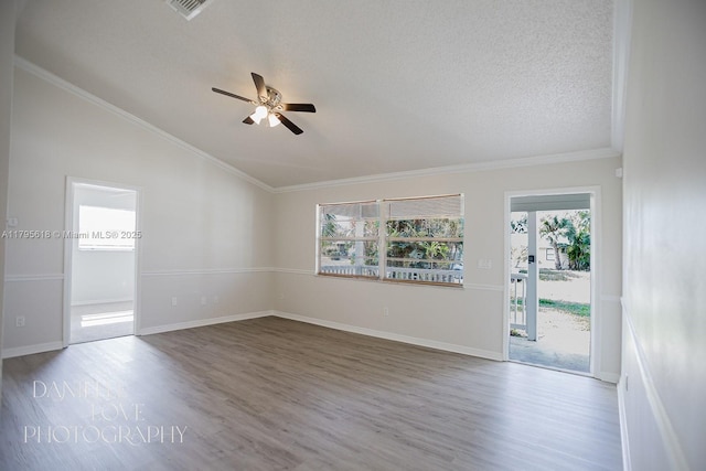 557 NW Fairfax Ave, Port St Lucie, FL 34983 - unfurnished room with vaulted ceiling, a ceiling fan, a healthy amount of sunlight, and wood finished floors