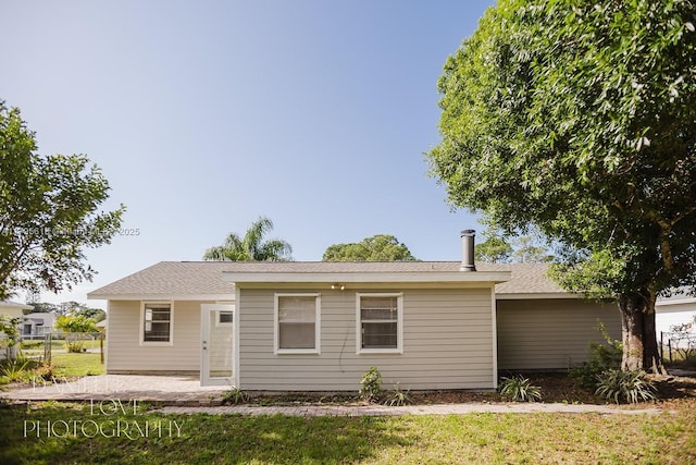 557 NW Fairfax Ave, Port St Lucie, FL 34983 - rear view of property with a lawn, a patio area, and fence