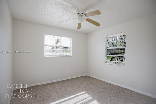 557 NW Fairfax Ave, Port St Lucie, FL 34983 - spare room with a textured ceiling, carpet floors, a ceiling fan, and baseboards