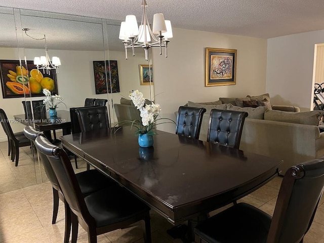 dining space featuring a chandelier and a textured ceiling