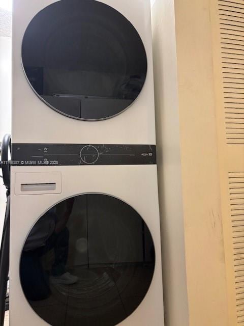 laundry area with laundry area and stacked washing maching and dryer