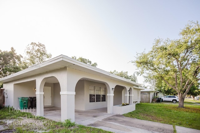 view of side of property featuring a yard and stucco siding
