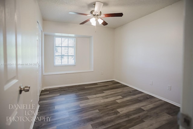 spare room featuring a textured ceiling, baseboards, a ceiling fan, and dark wood finished floors