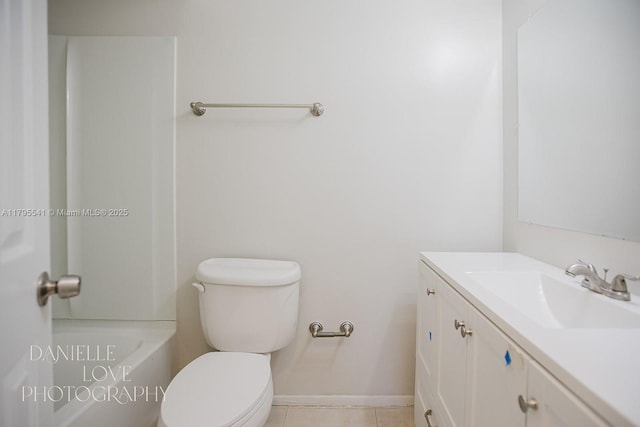bathroom featuring toilet, baseboards, tile patterned floors, and vanity