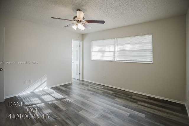 empty room featuring a textured ceiling, baseboards, a ceiling fan, and wood finished floors