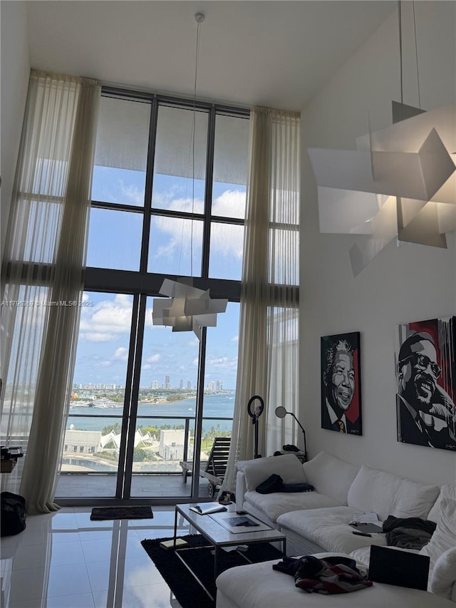 1100 Biscayne Blvd Unit 1704, Miami, FL 33132 - living room with floor to ceiling windows, a water view, tile patterned flooring, and a high ceiling