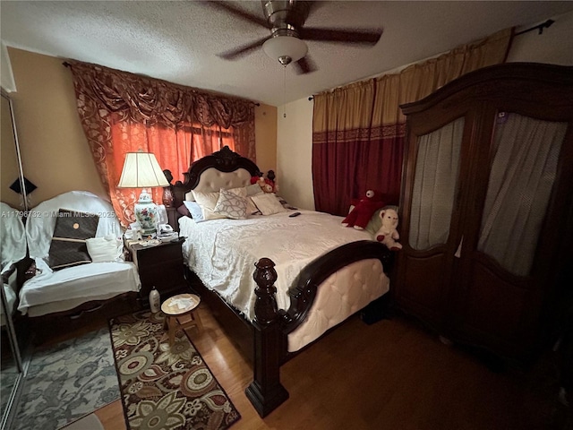 bedroom featuring ceiling fan, a textured ceiling, and wood finished floors