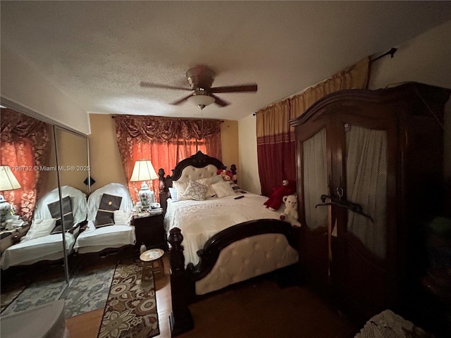 bedroom with ceiling fan and a textured ceiling