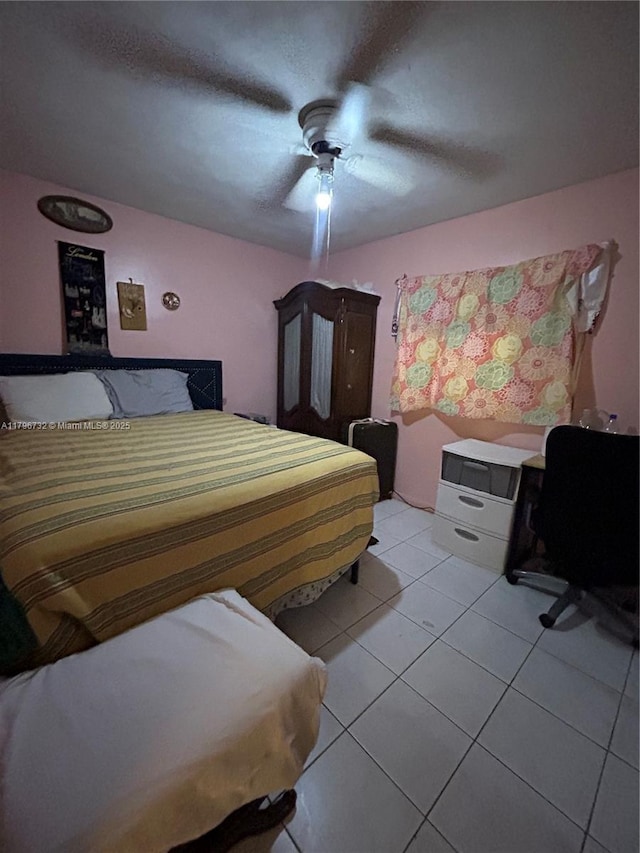 bedroom with a ceiling fan and light tile patterned floors