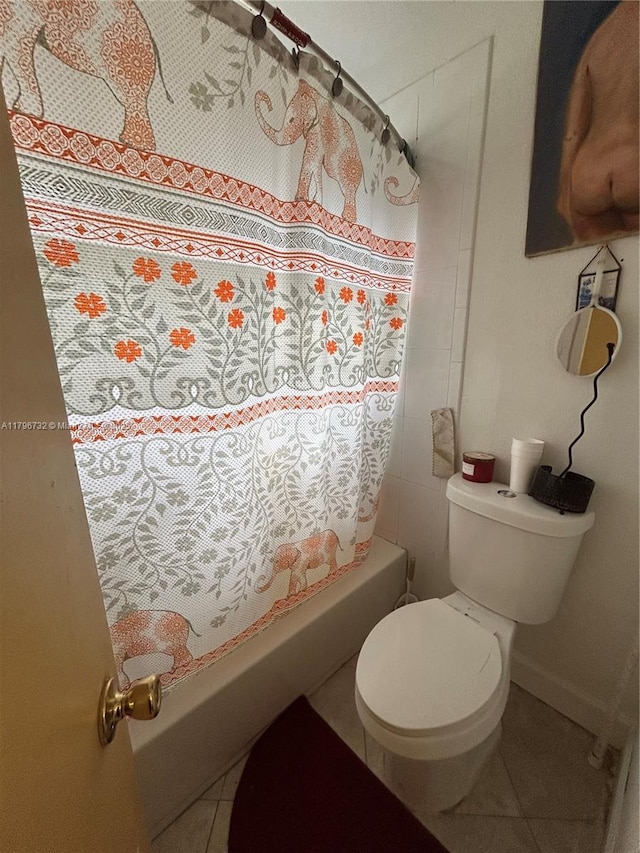 full bath with toilet, tile patterned flooring, and shower / tub combo
