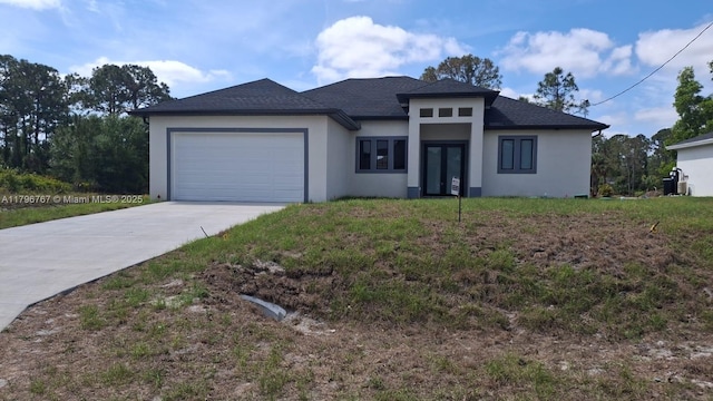 3501 W 70th St W, Lehigh Acres, FL 33971 - prairie-style house with stucco siding, driveway, an attached garage, and roof with shingles