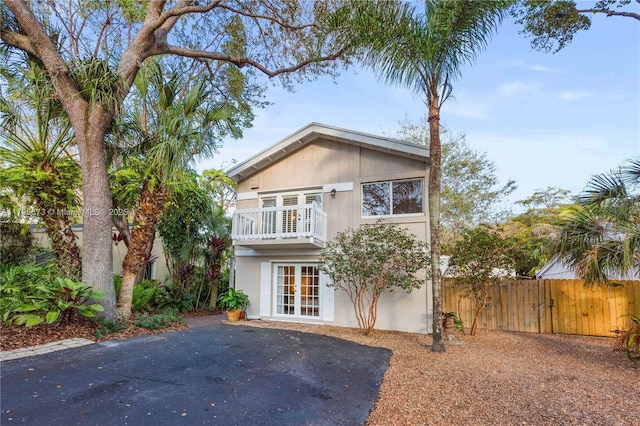 9033 SW 78th Pl, Miami, FL 33156 - view of front of house with french doors, fence, stucco siding, and a balcony