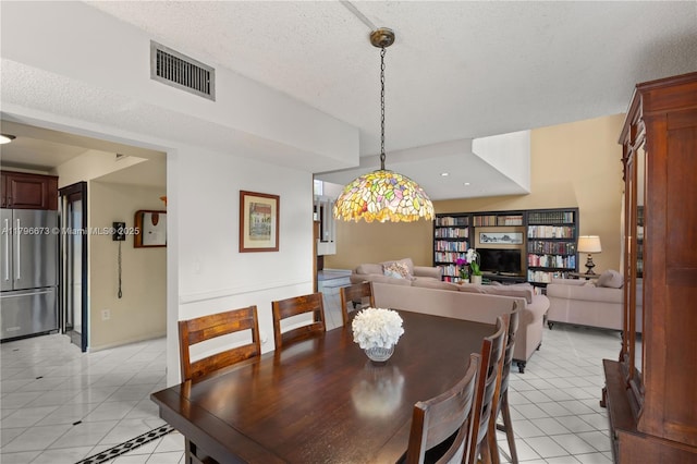 9033 SW 78th Pl, Miami, FL 33156 - dining room with light tile patterned flooring and a textured ceiling