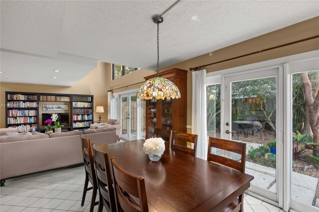 9033 SW 78th Pl, Miami, FL 33156 - dining space featuring light tile patterned floors, french doors, and a textured ceiling