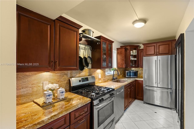 9033 SW 78th Pl, Miami, FL 33156 - kitchen with appliances with stainless steel finishes, a sink, light stone counters, tasteful backsplash, and glass insert cabinets