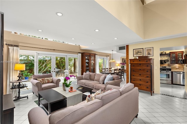 9033 SW 78th Pl, Miami, FL 33156 - living room featuring healthy amount of natural light, recessed lighting, light tile patterned floors, and french doors