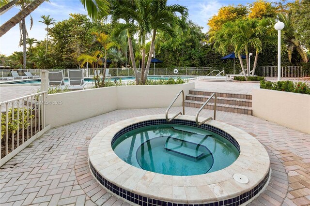 9033 SW 78th Pl, Miami, FL 33156 - community pool featuring a hot tub, fence, and a patio area