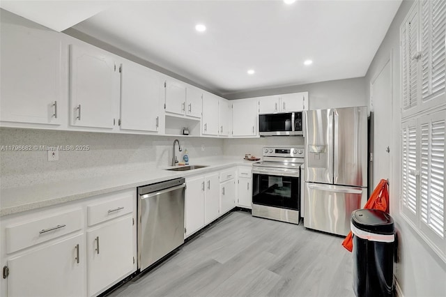 1301 NE 191st St Unit F417, Miami, FL 33179 - kitchen with a sink, stainless steel appliances, white cabinetry, light countertops, and recessed lighting