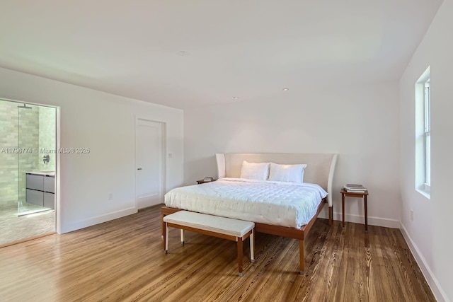 5812 Alton Rd, Miami Beach, FL 33140 - bedroom with connected bathroom, baseboards, and wood finished floors