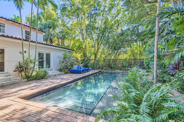 5812 Alton Rd, Miami Beach, FL 33140 - view of swimming pool featuring a fenced backyard, a patio, french doors, and a fenced in pool