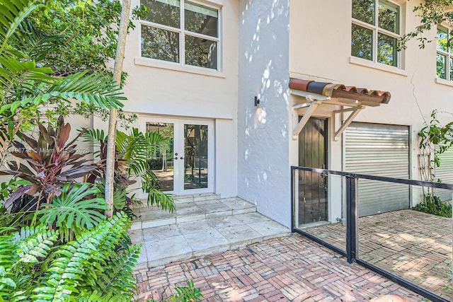 5812 Alton Rd, Miami Beach, FL 33140 - doorway to property featuring stucco siding and french doors