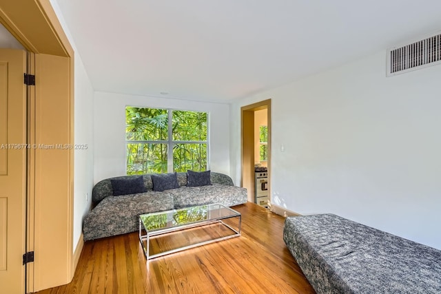 5812 Alton Rd, Miami Beach, FL 33140 - living room featuring baseboards, visible vents, and wood finished floors