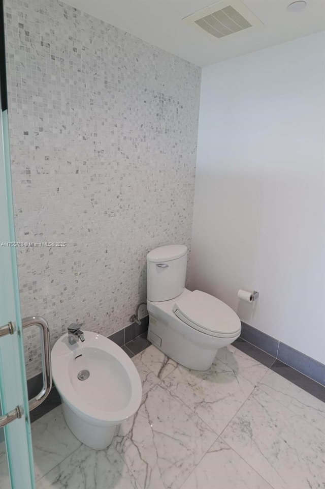 200 S Biscayne Blvd Unit 3903, Miami, FL 33131 - bathroom featuring a bidet and marble look tiles