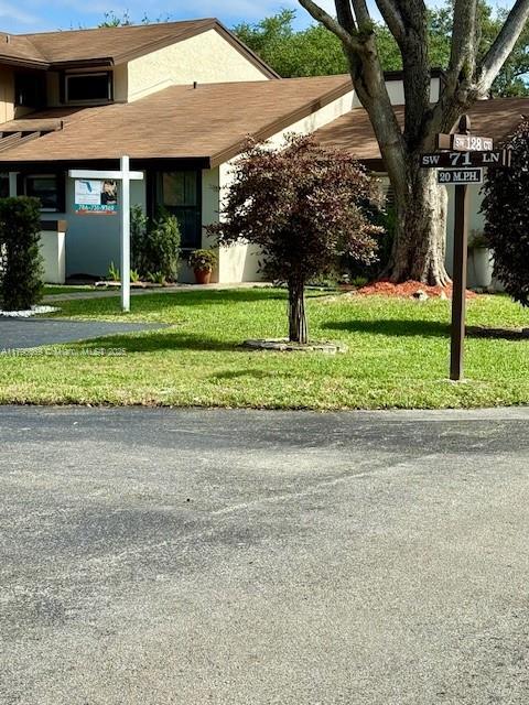 12815 SW 71st Ln, Miami, FL 33183 - view of front of property featuring a front lawn, stucco siding, and a shingled roof