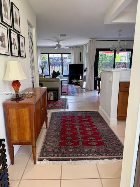 12815 SW 71st Ln, Miami, FL 33183 - hall featuring light tile patterned floors and a chandelier