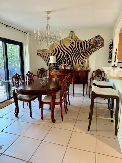 12815 SW 71st Ln, Miami, FL 33183 - dining area with a chandelier and light tile patterned flooring