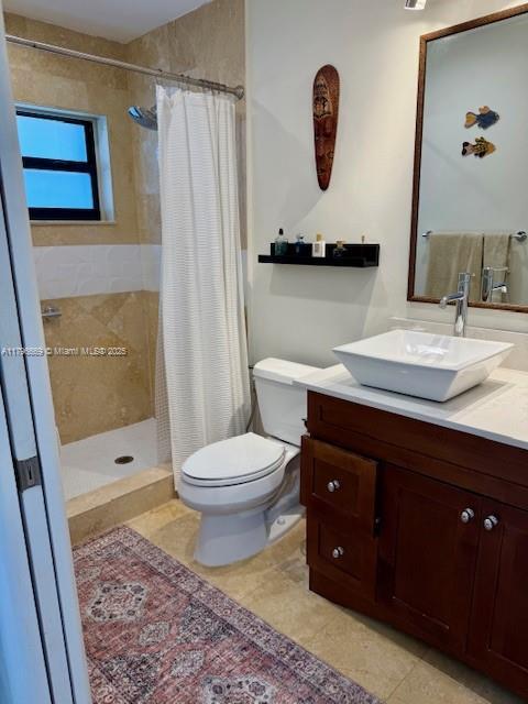 12815 SW 71st Ln, Miami, FL 33183 - bathroom with tile patterned floors, toilet, a tile shower, and vanity