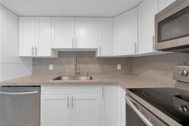 200 Galen Dr Unit 308, Key Biscayne, FL 33149 - kitchen with a sink, white cabinetry, light countertops, appliances with stainless steel finishes, and tasteful backsplash