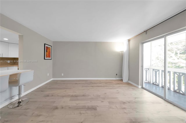 200 Galen Dr Unit 308, Key Biscayne, FL 33149 - unfurnished living room featuring baseboards and light wood-type flooring