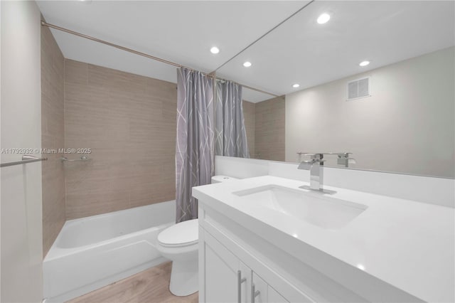 200 Galen Dr Unit 308, Key Biscayne, FL 33149 - full bath featuring toilet, shower / tub combo with curtain, visible vents, vanity, and wood finished floors