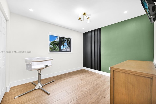 interior space with baseboards, light wood-type flooring, and recessed lighting