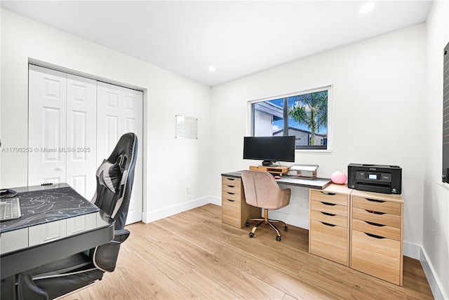 office space featuring baseboards, light wood-style floors, and recessed lighting