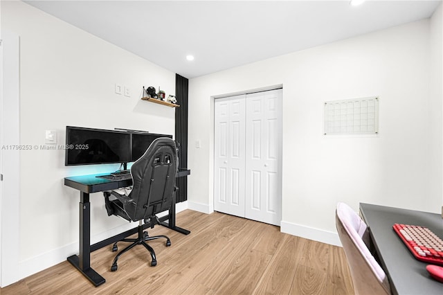 office area featuring baseboards, light wood-style flooring, and recessed lighting