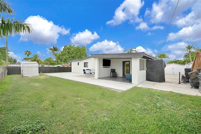 rear view of property featuring a fenced backyard, a patio, and a lawn