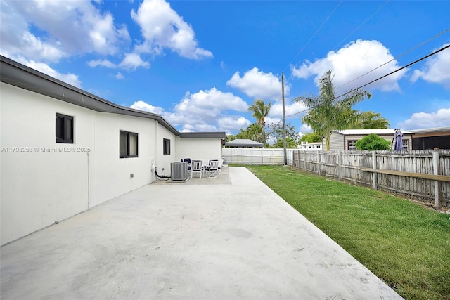 view of yard featuring central AC unit, a patio, and a fenced backyard