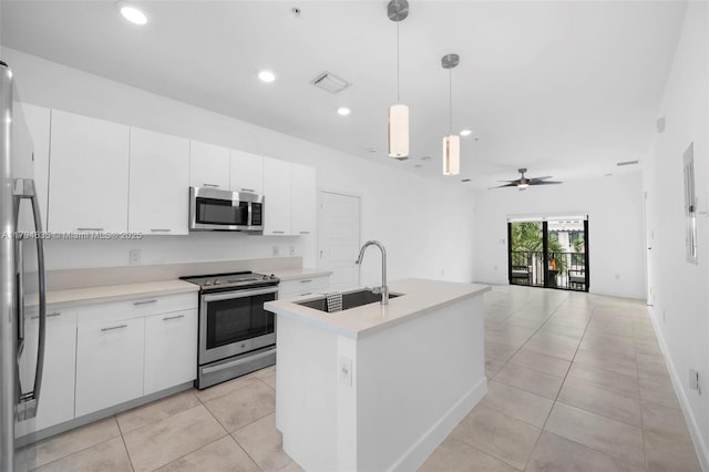 kitchen featuring visible vents, a sink, white cabinetry, light countertops, and appliances with stainless steel finishes